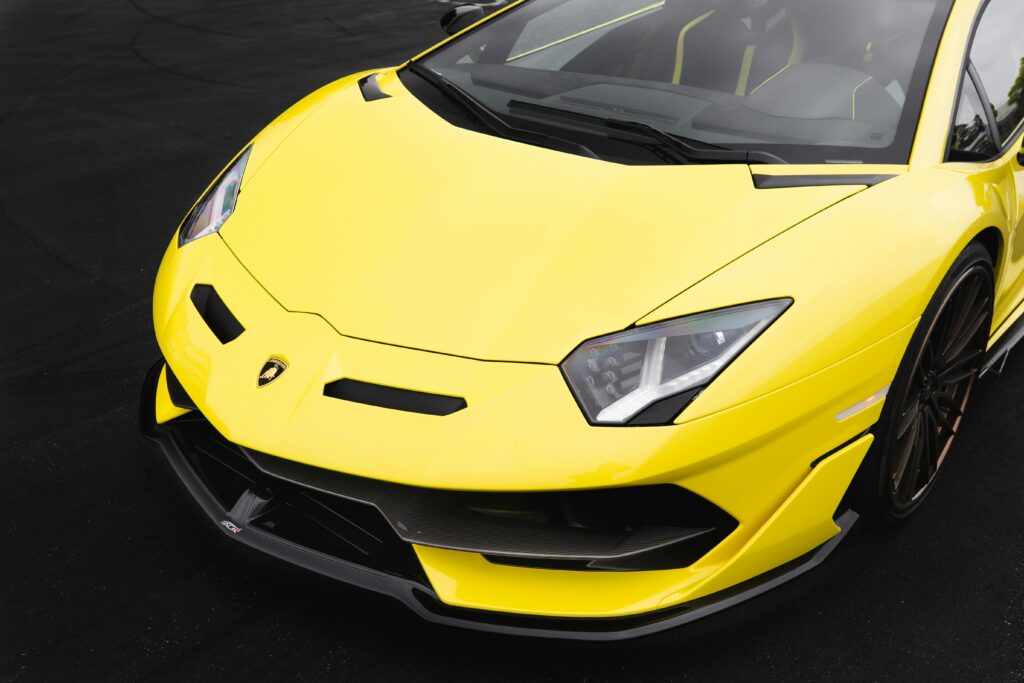 A vibrant yellow Lamborghini Aventador supercar with sleek design details, captured in a close-up angle.